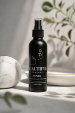 Load image into Gallery viewer, Black toner bottle labeled 'Beautiful Company' on a neutral background with a marble object and plant leaves.
